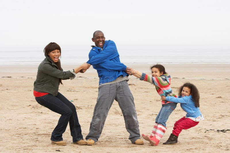 Family Having Fun On Winter Beach royalty free stock photo Family Having Fun On Winter Beach royalty free stock photo