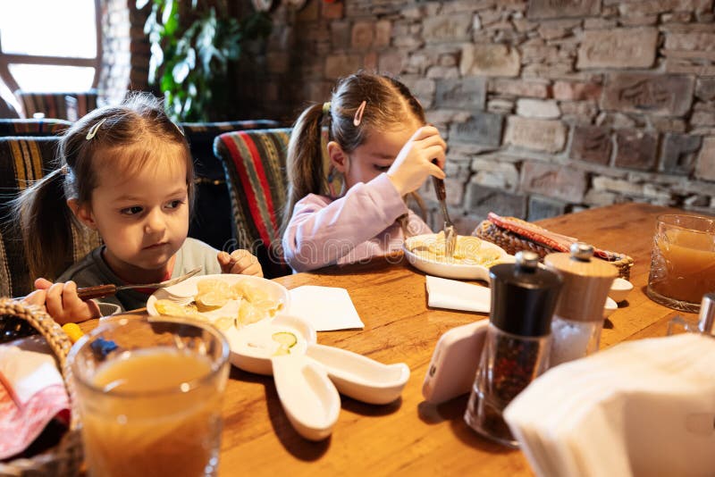Family Having a Meal Together in Authentic Ukrainian Restaurant. Girls ...
