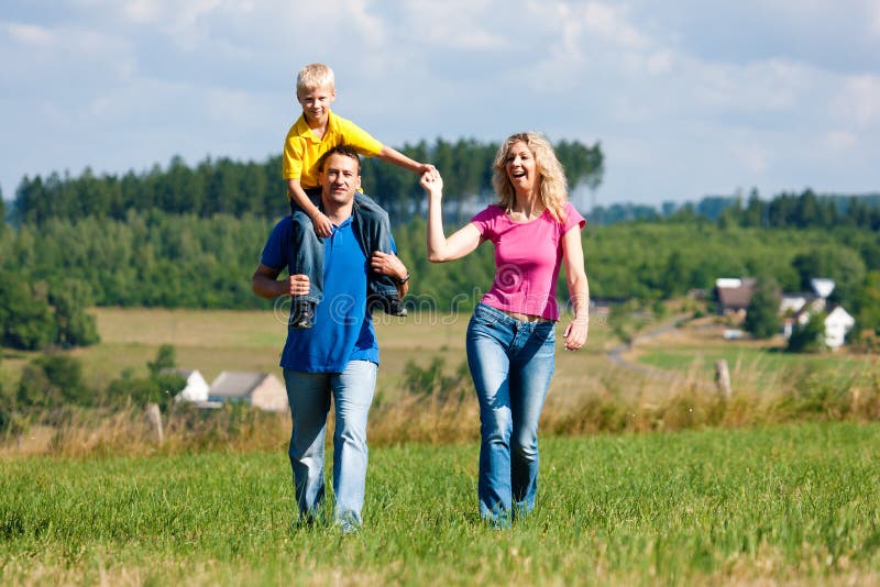 Family having walk on meadow