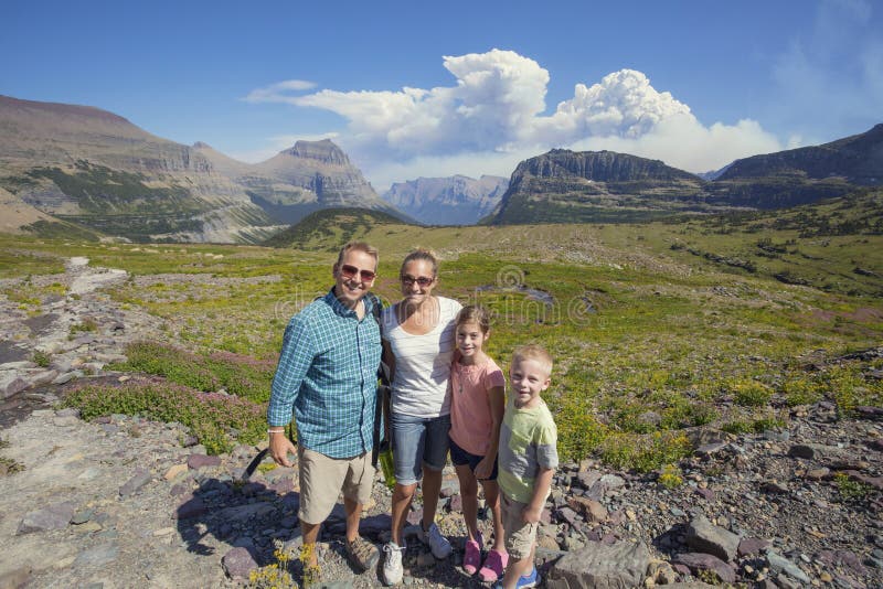 An active family hiking at high elevation in the gorgeous mountains of Glacier National Park in Montana, United States. Lots of copy space. An active family hiking at high elevation in the gorgeous mountains of Glacier National Park in Montana, United States. Lots of copy space