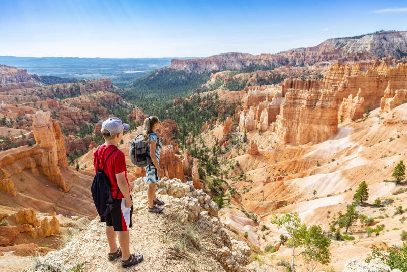 Family hiking in Bryce Canyon National Park, Utah, USA looking out at a scenic view