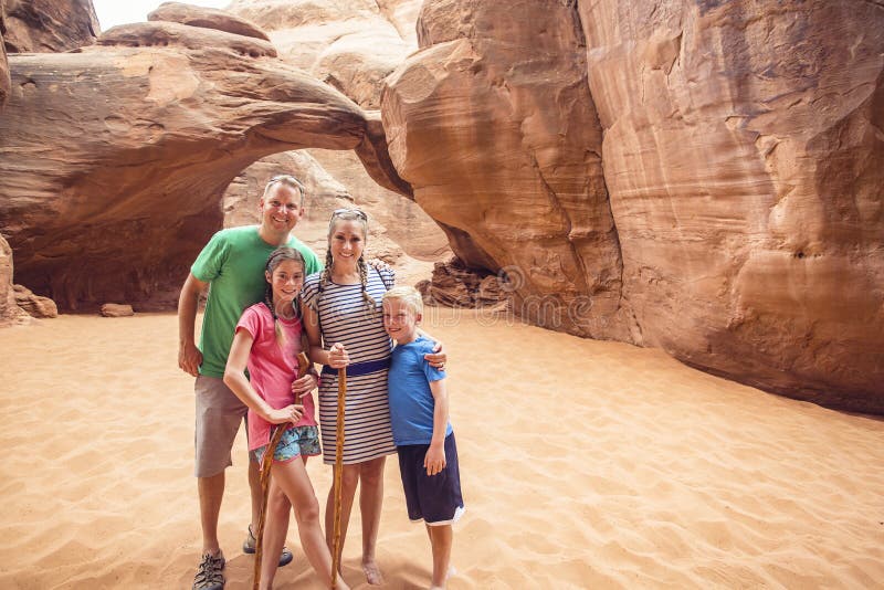 Family hiking and sightseeing together at Arches National Park