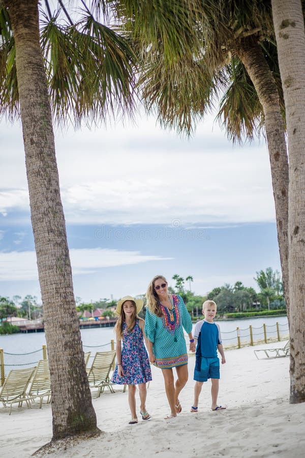 Family walking together on a beach at a tropical beach resort