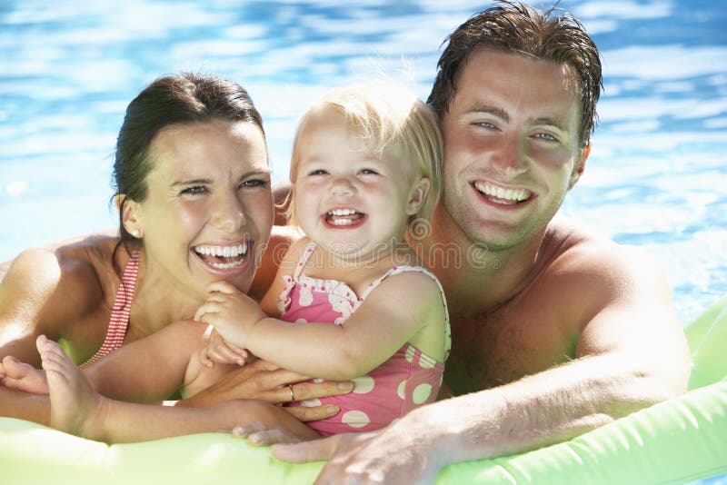 Family On Holiday In Swimming Pool