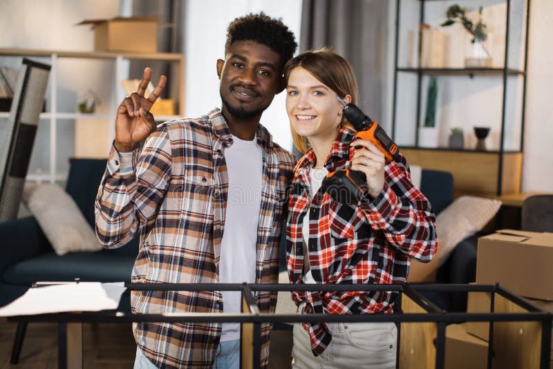 Family at home showing peace gesture and holding screwdriver royalty free stock photo