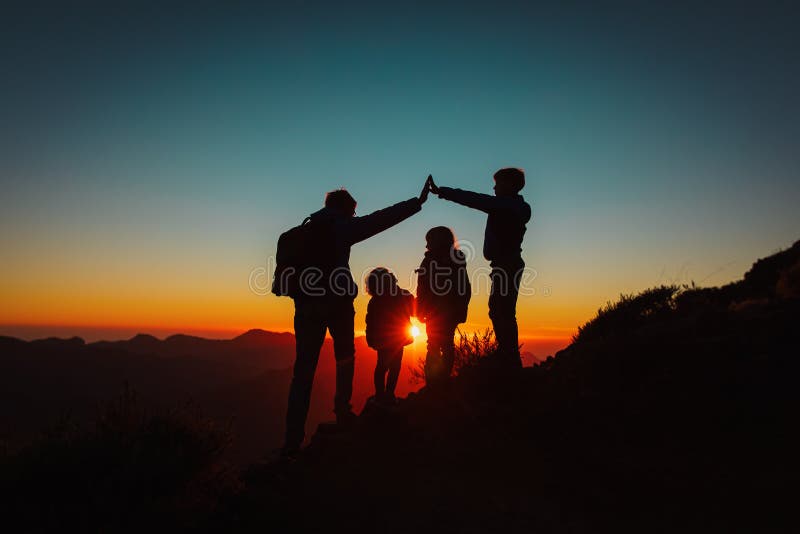 Family with kids travel in sunset mountains, parenting concept