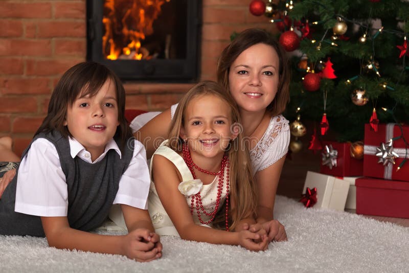 Family laying by the fire on Christmas eve stock images Family laying by the fire on Christmas eve stock images