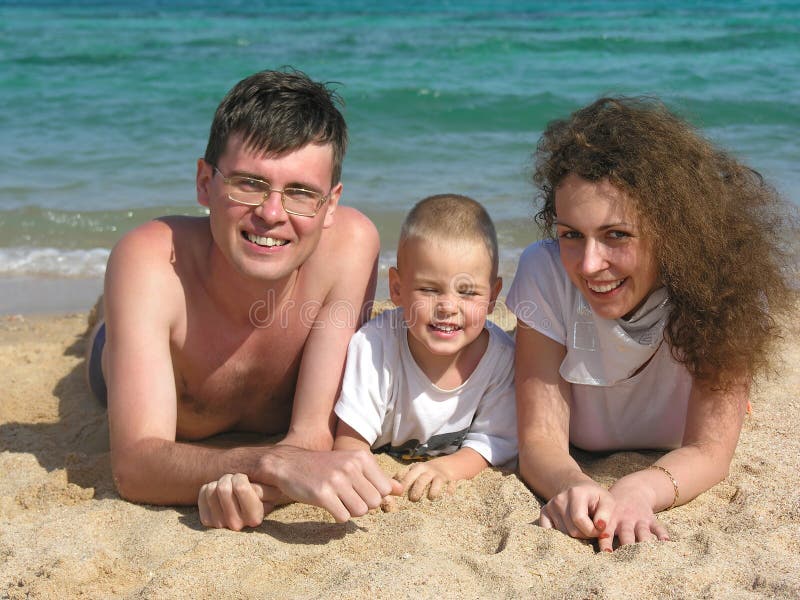 Family lies on beach 2