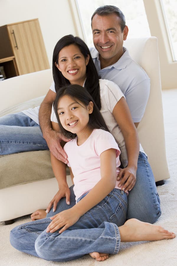 Family in living room smiling looking at camera