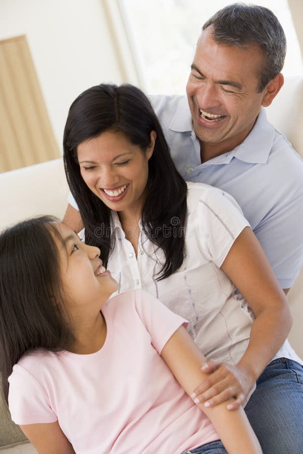 Family in living room smiling at each other