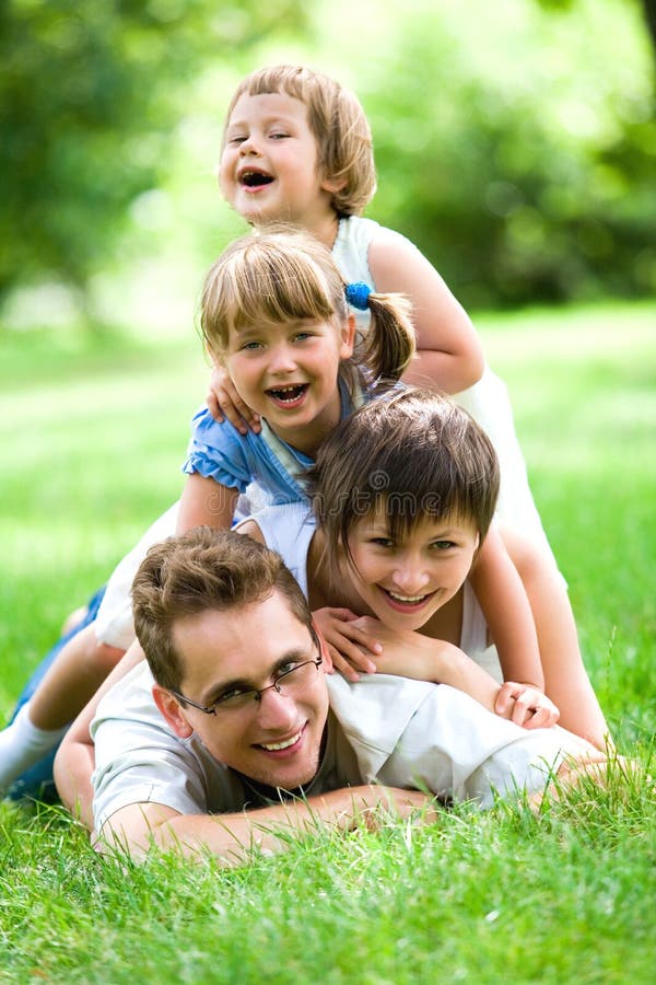 Family lying on grass