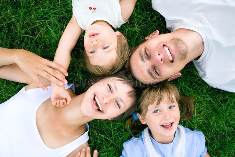 Family lying on grass