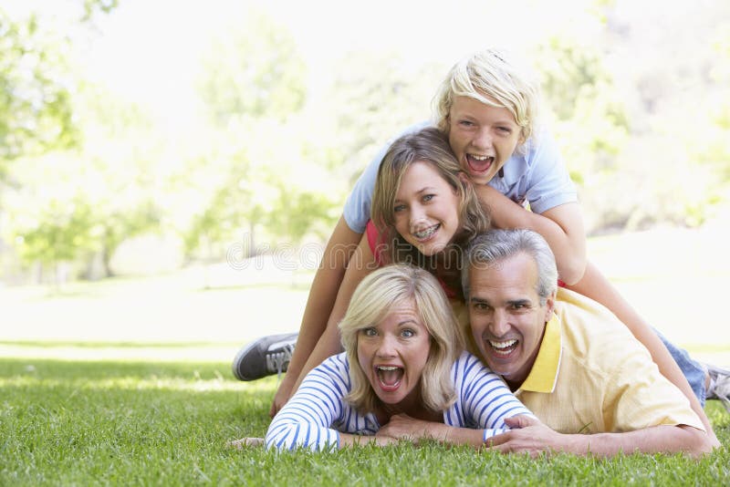 Family Lying On Top Of Each Other In A Park stock photos Family Lying On Top Of Each Other In A Park stock photos