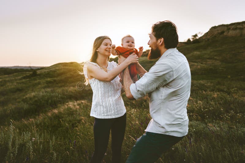 Family mother and father holding baby outdoor stock photography Family mother and father holding baby outdoor stock photography