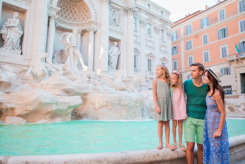 Family near Fontana di Trevi, Rome, Italy. Happy parents and kids enjoy italian vacation holiday in Europe.