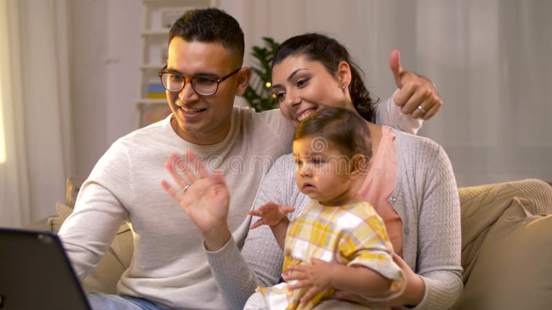 Family with tablet pc having video call at home