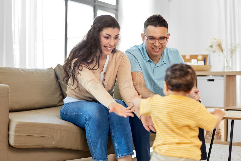 Happy family with child sitting on sofa at home
