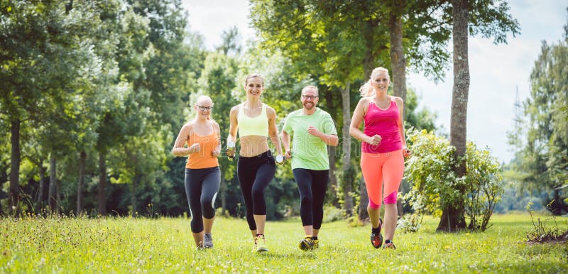 Family with Personal Fitness Trainer Jogging Stock Image - Image of ...