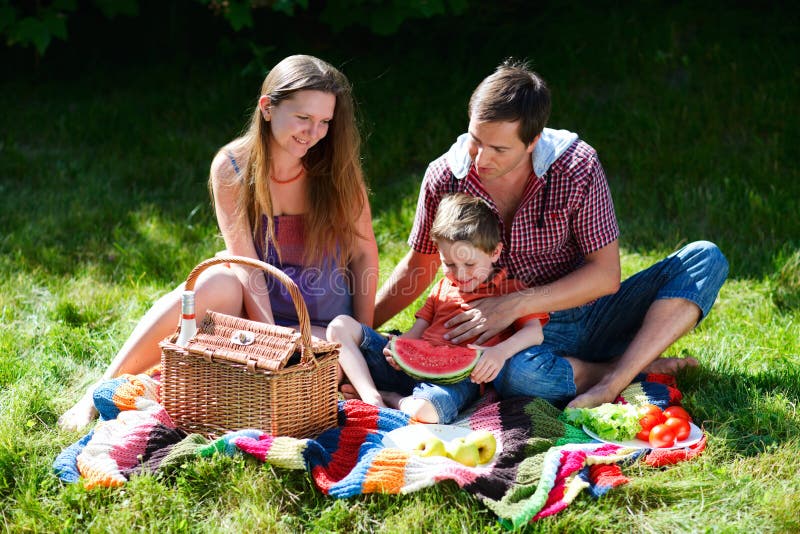 Young family having picnic on summer sunny day. Young family having picnic on summer sunny day