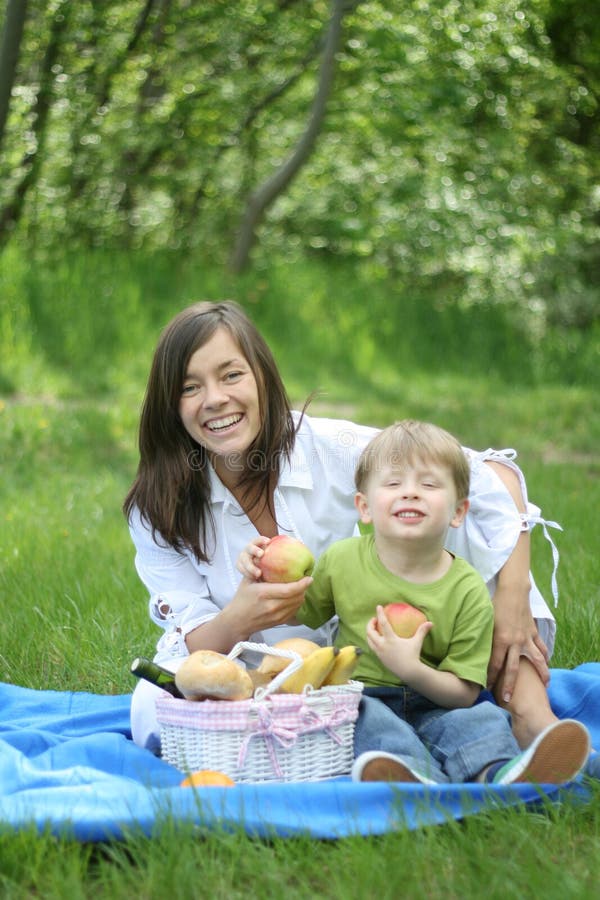 Mother and son relaxing - family picnic in the forest