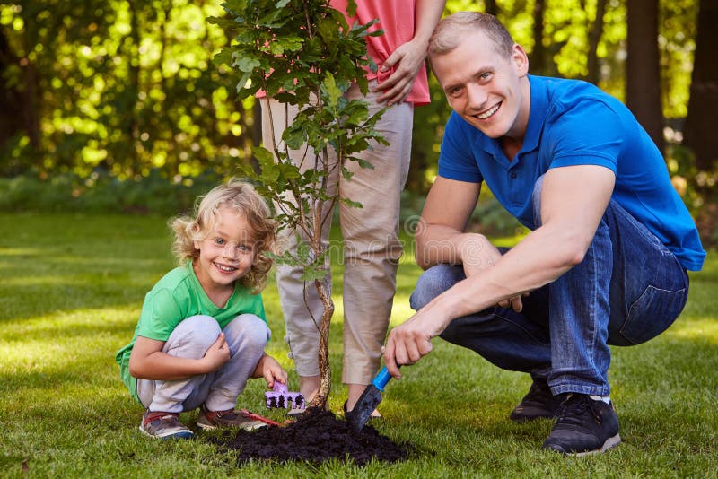 Family planting a tree stock photo. Image of tree, garden - 92476030