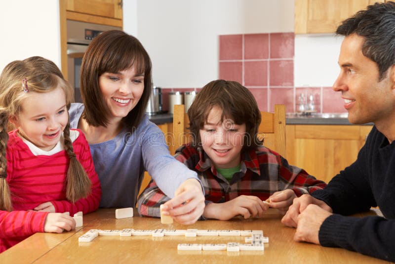 Family Playing Dominoes In Kitchen