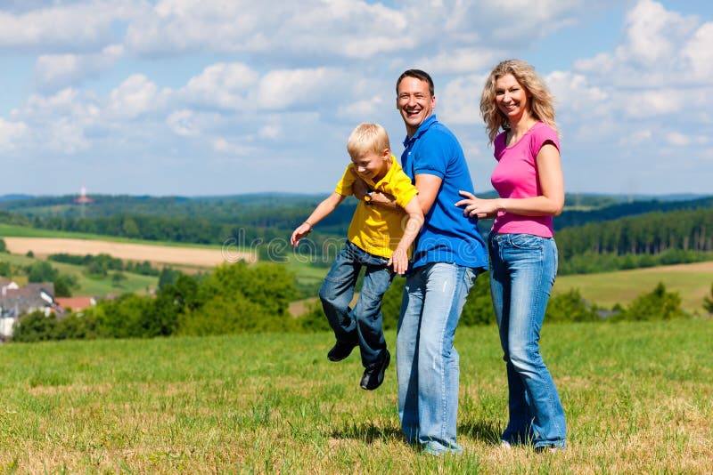 Family playing on meadow in summer