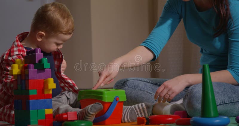 Family Playing Together Mother and Child with Toys and Building Blocks