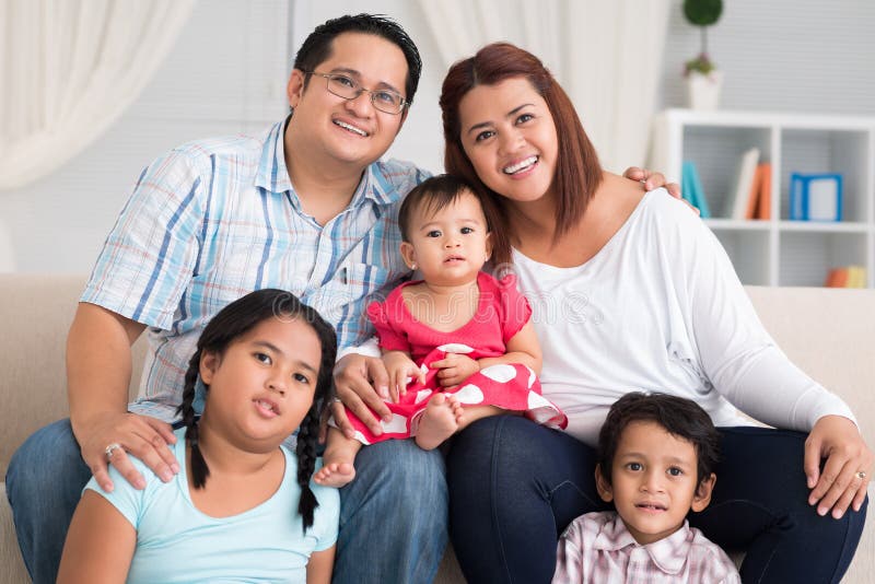 Close-up portrait of a big friendly family smiling and looking at camera. Close-up portrait of a big friendly family smiling and looking at camera