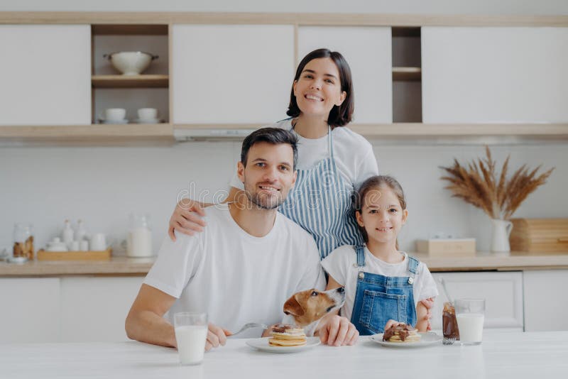 Family Portrait of Happy Mother, Daughter and Father Pose at Kitc picture