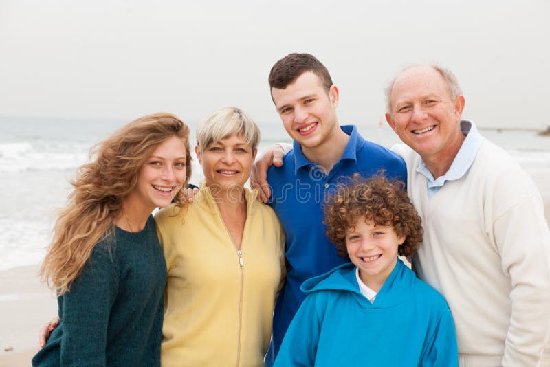 Family posing on beach background stock photos