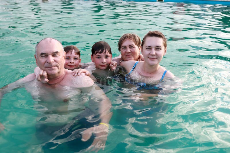 Family posing in open pool stock images