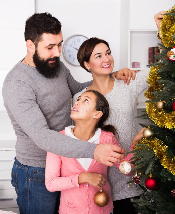 Family Putting Decorations on Christmas Tree Stock Photo - Image of ...