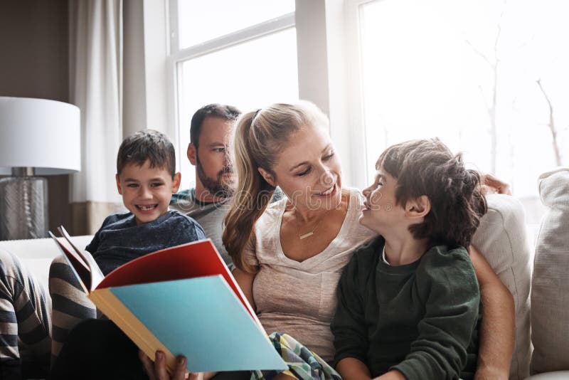 Family, reading book with parents and kids, happiness at home with story time and learning. Love, relationship and happy royalty free stock photography