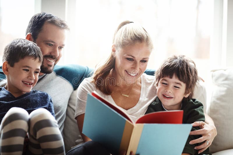 Family, reading book together with parents and children, happiness at home with story time and learning. Love stock photography