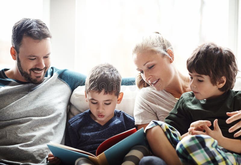 Family, reading book together with parents and kids, happiness at home with story time and learning. Love, relationship royalty free stock photography