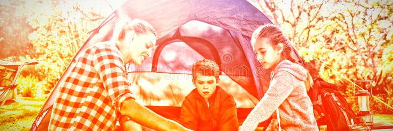 Family reading the map outside the tent royalty free stock photos Family reading the map outside the tent royalty free stock photos