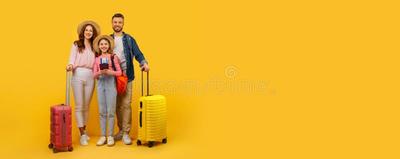Family ready for vacation with luggage on yellow background stock image