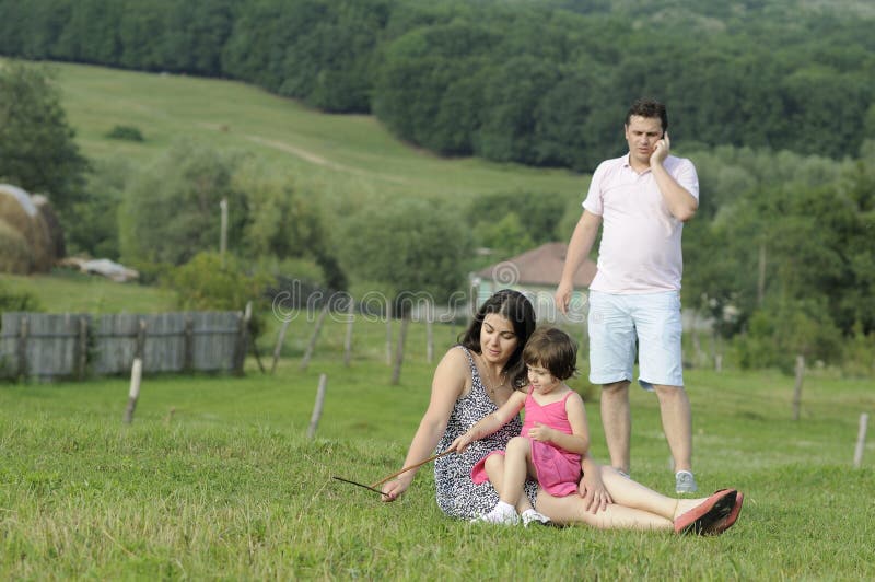 Family relaxing and busy father