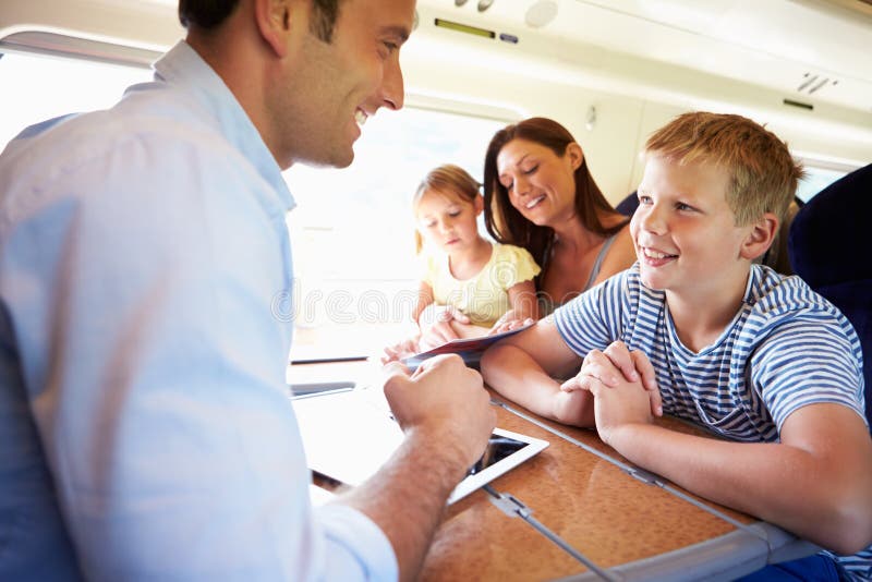 Family Relaxing On Train Journey stock photo Family Relaxing On Train Journey stock photo