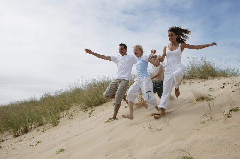 Family running at the beach