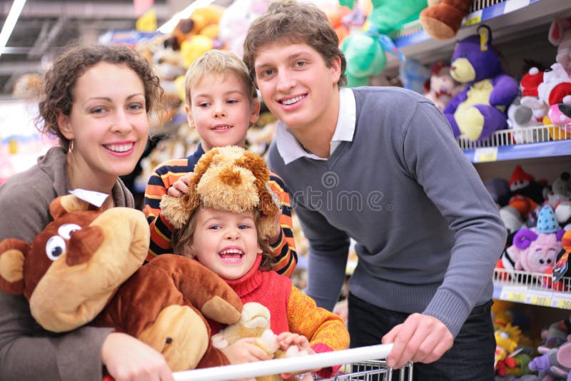 Family in shop with soft toys stock images Family in shop with soft toys stock images