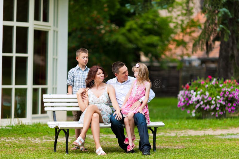 Family sitting in front of their home