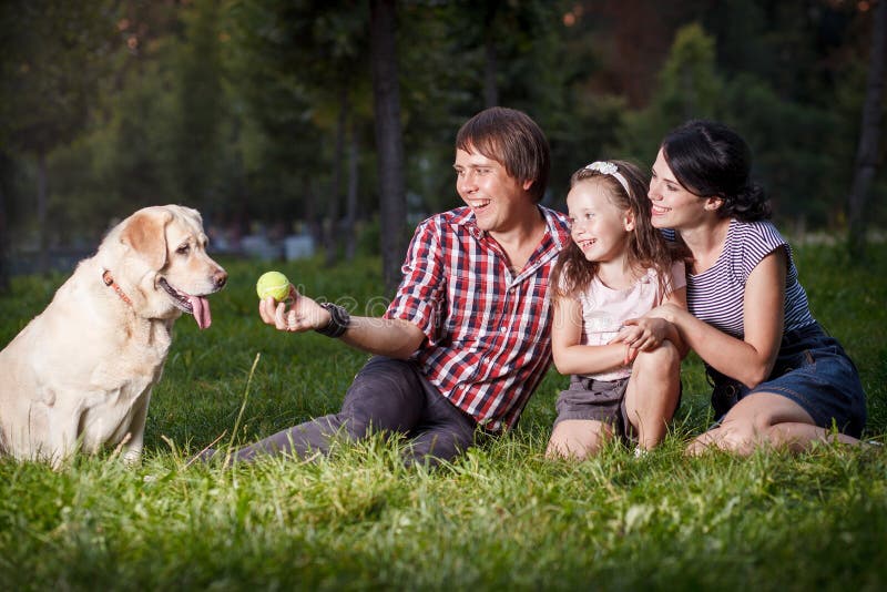 Young family relaxing in the park daughter mother father. Young family relaxing in the park daughter mother father