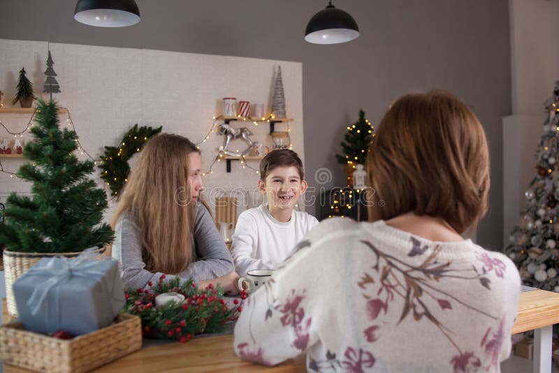 A family sitting at a table and talking in christmas stock image