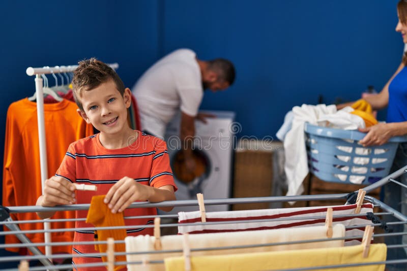 Family Smiling Confident Doing Laundry at Laundry Room Stock Image