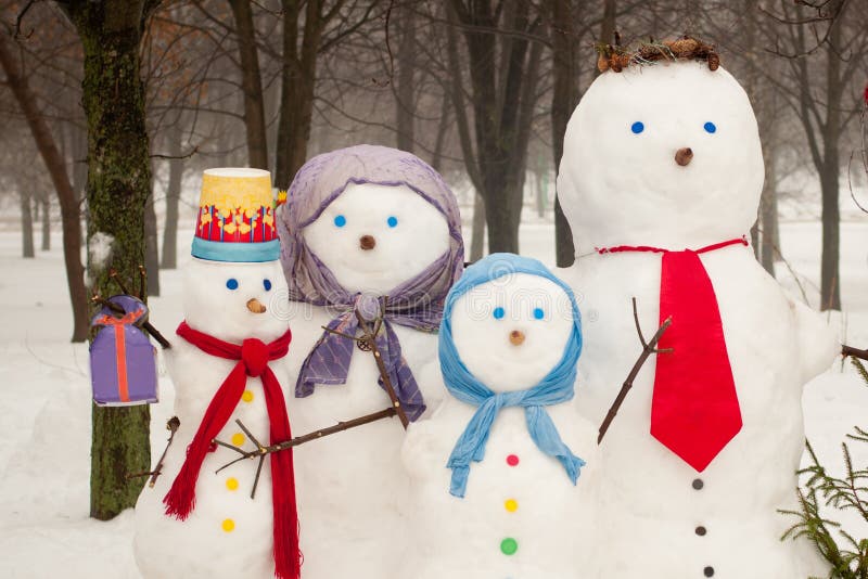 Family of snowmen outdoors stock photo. Image of snowman 66220530