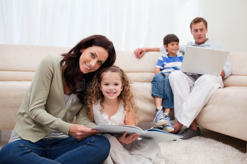 Family spending leisure time in the living room royalty free stock photo Family spending leisure time in the living room royalty free stock photo