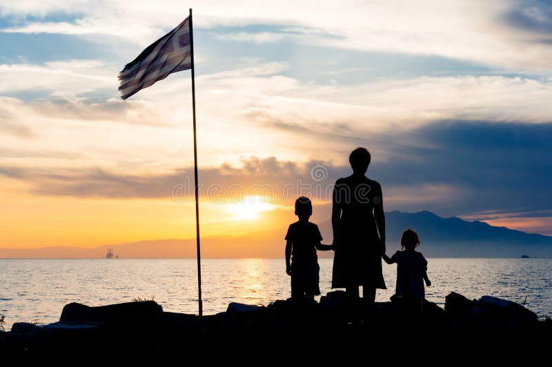 Family sunset silhouette on Thassos island Greece