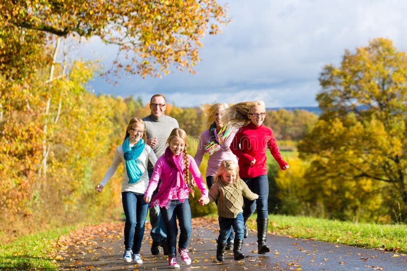 Family take a walk in autumn forest